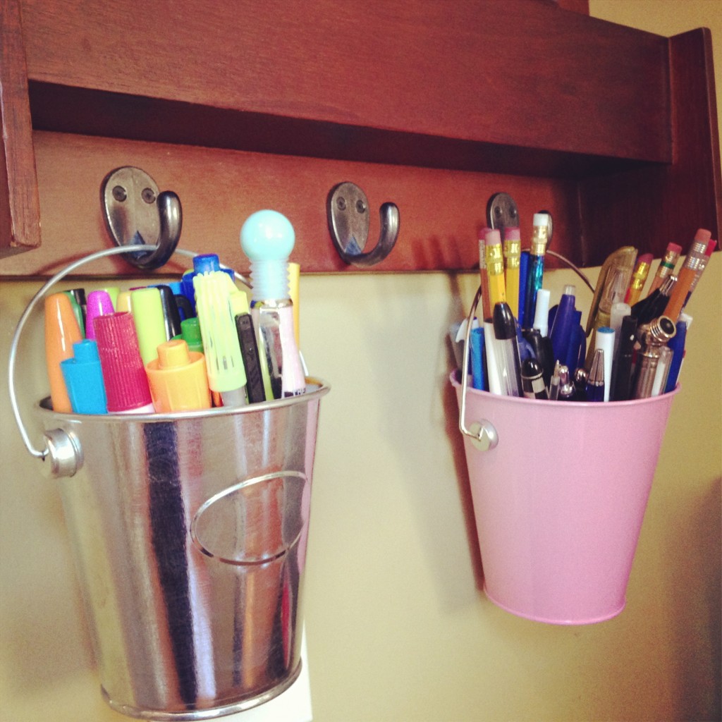 Little buckets holding pins and markers